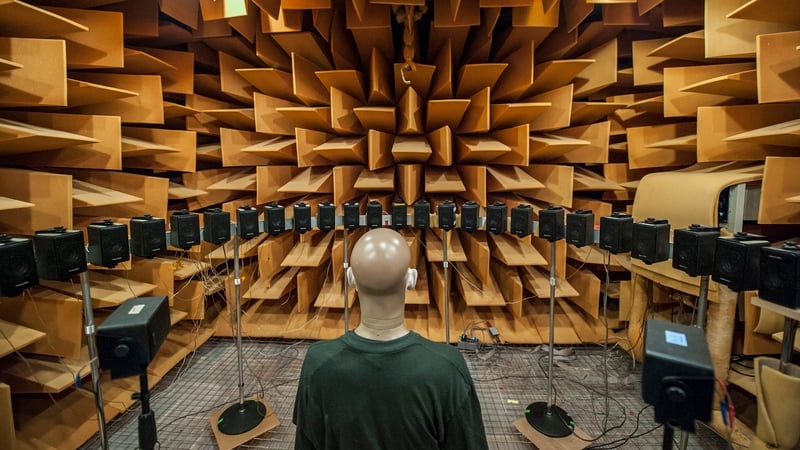 A mannequin surrounded by speakers in a soundproof room for testing communication sciences and disorders at Michigan State University.