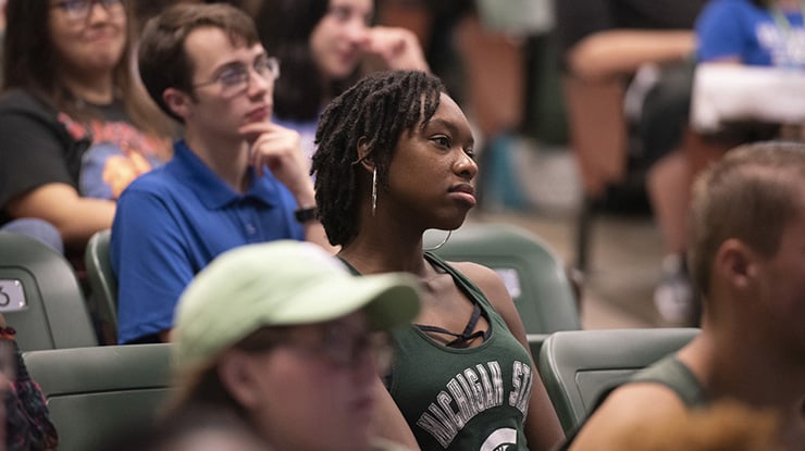 An MSU student in the international studies major sitting in a lecture hall contemplating the ideas being presented.