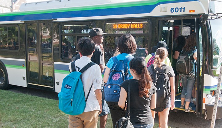 Michigan State University students boarding a bus for getting around campus