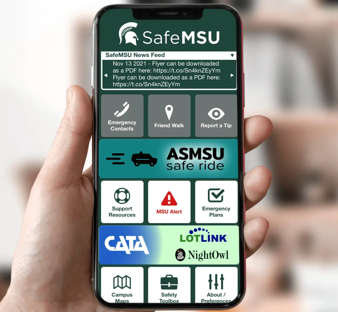 A smartphone being held up with the screen displaying the SafeMSU app which provides campus safety resources for students.