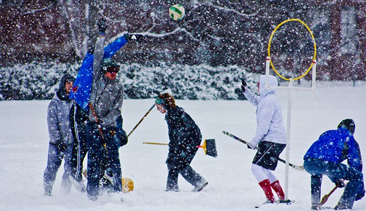 Students in the MSU Quidditch club playing outside in the snow.